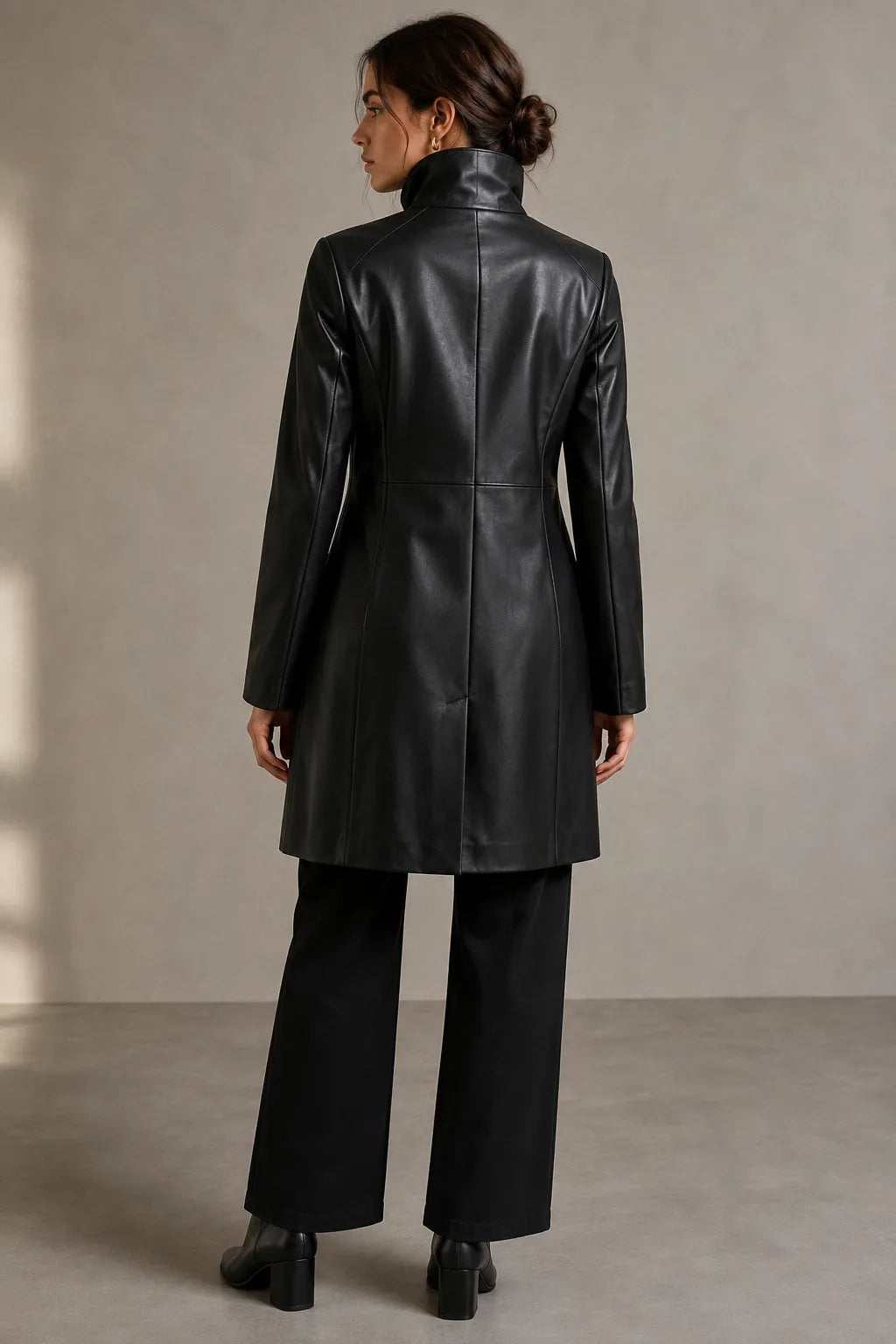 Women's black funnel-neck leather coat, stand collar, back view