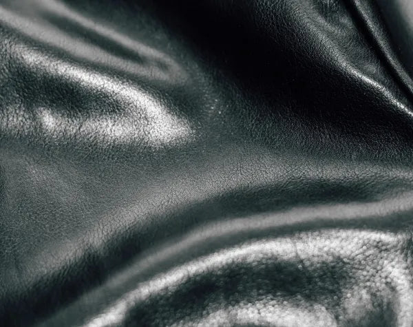 Close-up of dark gray leather texture with folds
