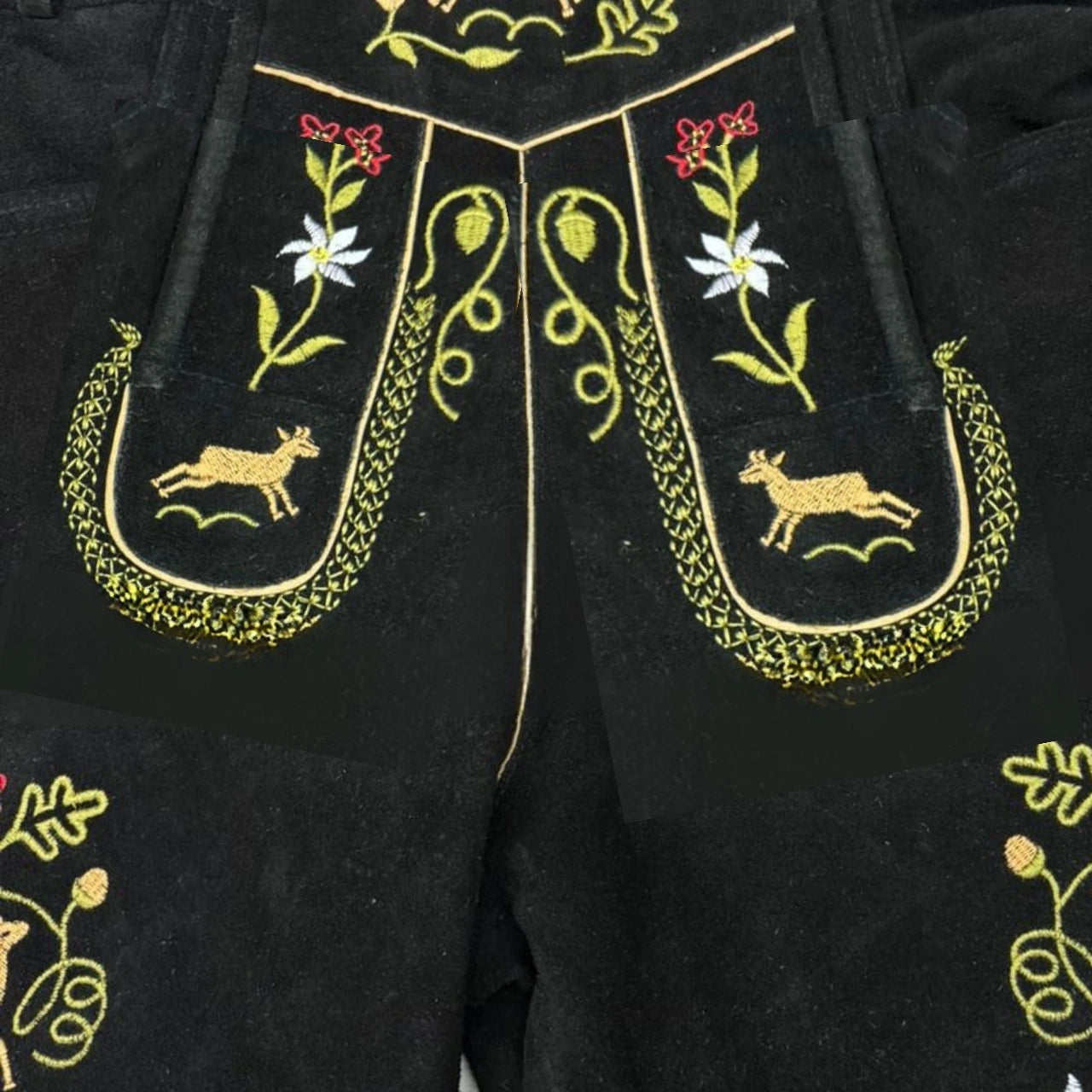 Black pants with gold embroidery featuring animals and plants on a dark background