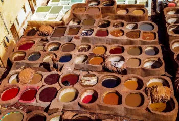 Assorted spices in wooden containers on a market stall