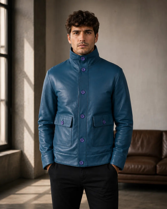 Man wearing a blue jacket in a room with a window and sofa.