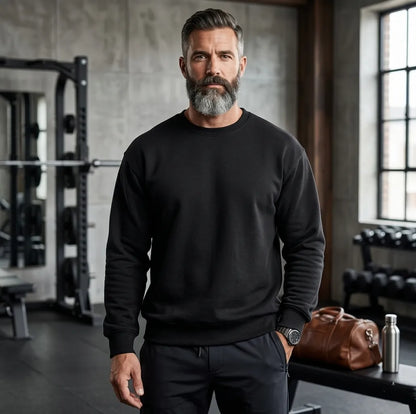 Man wearing a black sweatshirt in a gym setting