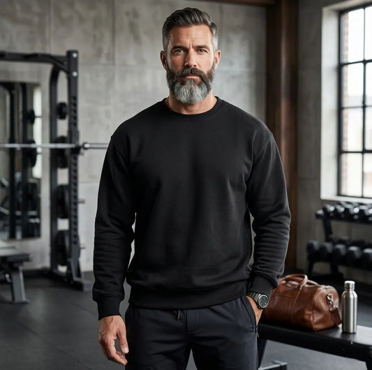 Man wearing a black sweatshirt in a gym setting