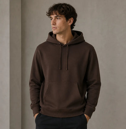 Man wearing a brown hoodie against a plain background