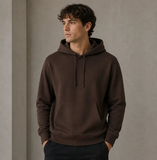 Man wearing a brown hoodie against a plain background