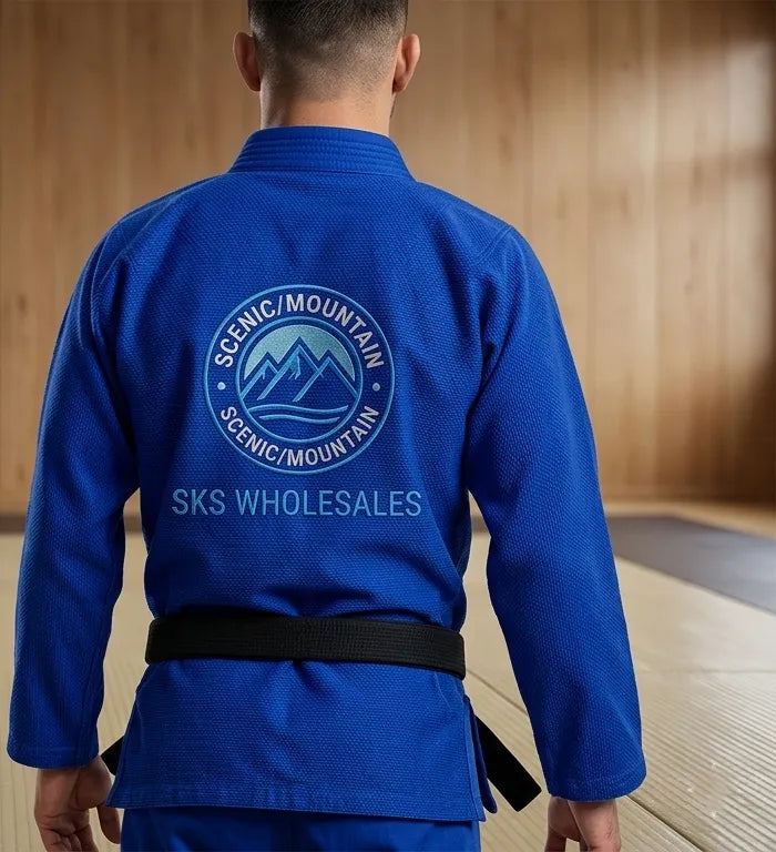 Person wearing a blue martial arts uniform with Scenic Mountain branding.