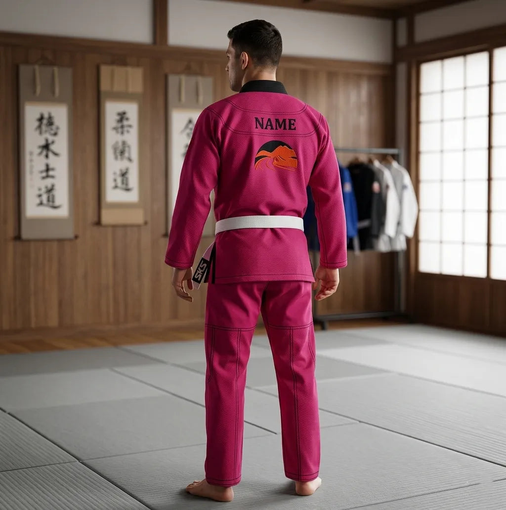 Person wearing a pink martial arts uniform in a dojo setting