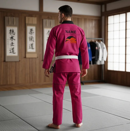 Person wearing a pink martial arts uniform in a dojo setting