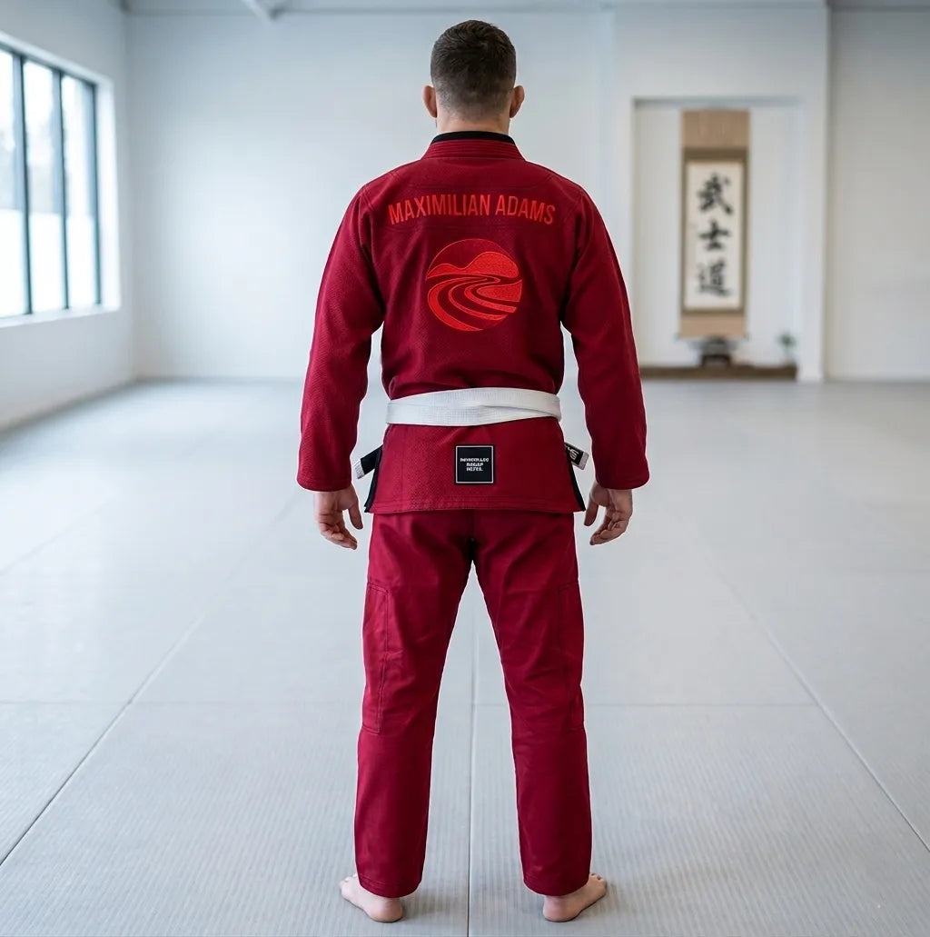 Person wearing a red martial arts uniform in a dojo.