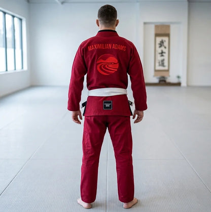 Person wearing a red martial arts uniform in a dojo.