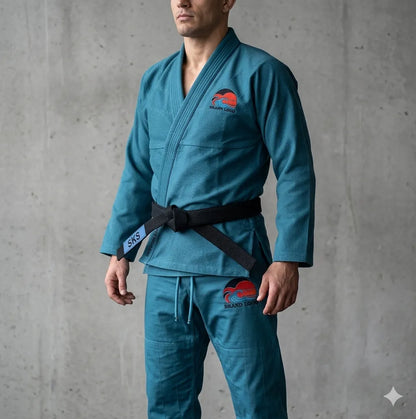 Person wearing a blue martial arts uniform with a logo on a gray background