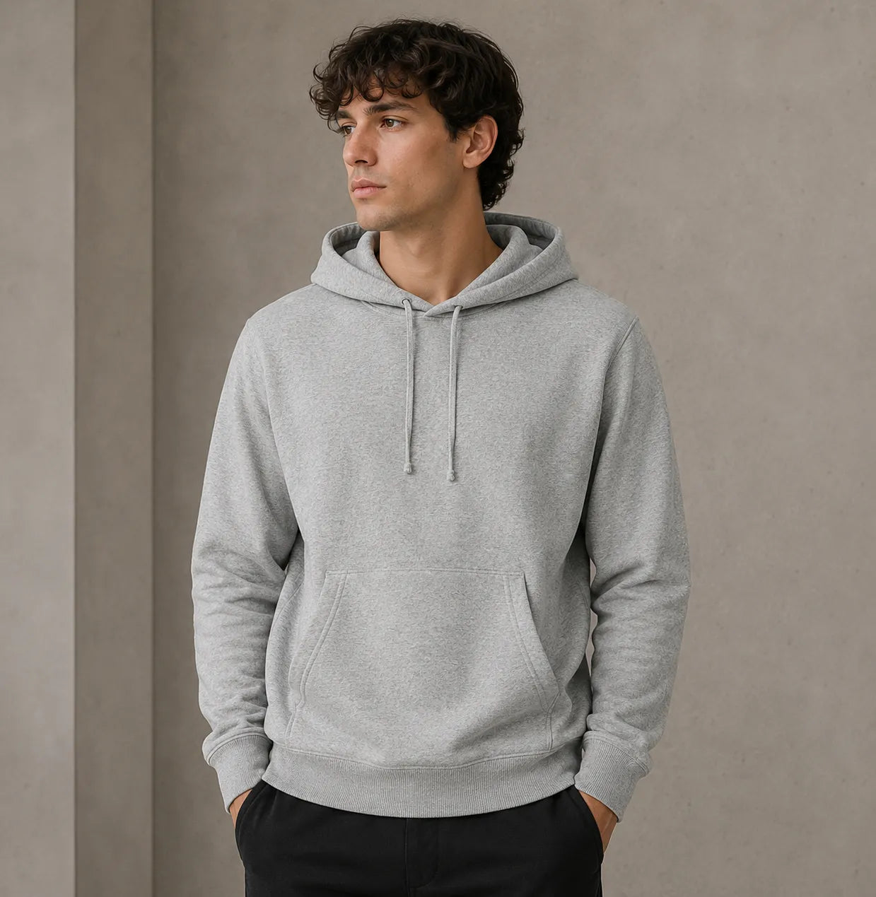 Man wearing a gray hoodie against a plain background