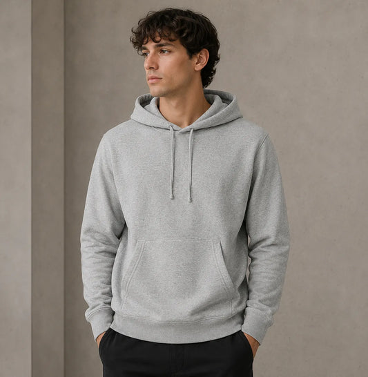 Man wearing a gray hoodie against a plain background
