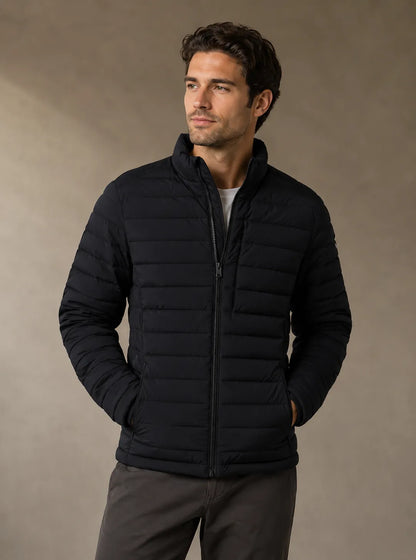 Man wearing a black puffer jacket against a beige background