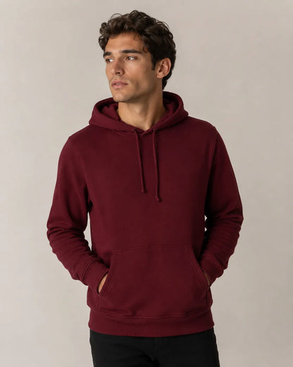 Man wearing a burgundy hoodie against a plain background