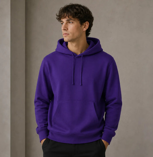 Man wearing a purple hoodie against a plain background