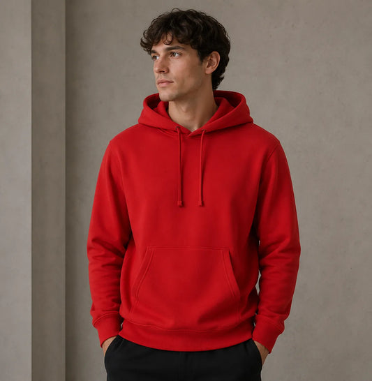 Man wearing a red hoodie against a neutral background