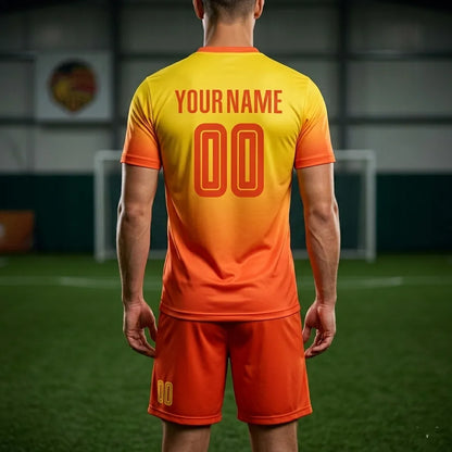 Person wearing an orange and yellow sports jersey with customizable text on a blurred sports field background